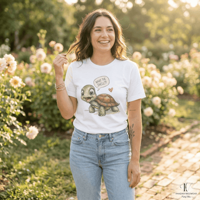A woman wearing a What the Shell turtle shirt with a watercolor tortoise design, smiling in a rose garden.