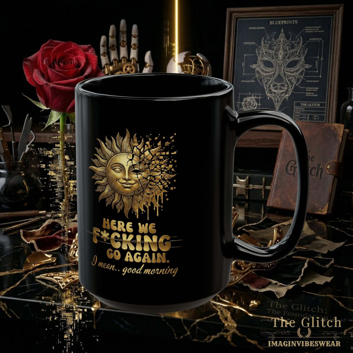 A black-and-gold sarcastic morning mug featuring the phrase 'Here we f*cking go again... I mean... good morning.'